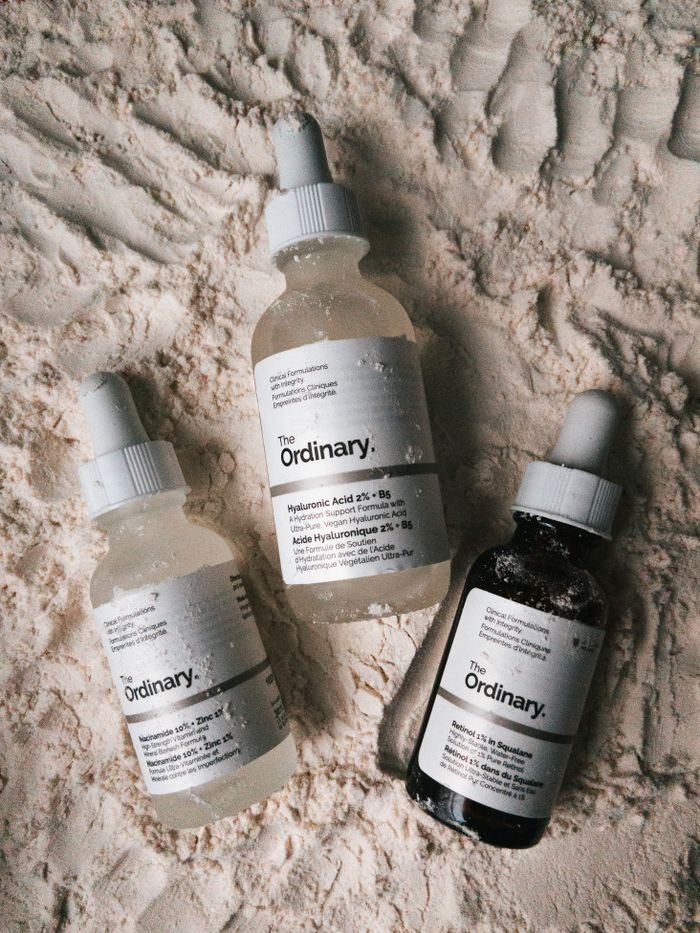 Mastering the First Impression: Your intriguing post title goes here Three dropper bottles of The Ordinary serums displayed on a powdery surface.